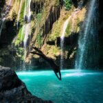 Woman diving into a wild pool for adventure