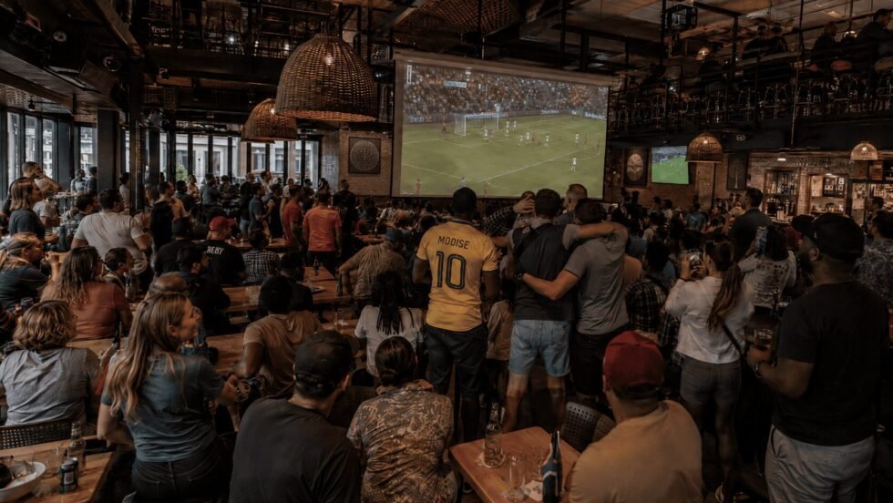A crowd gathered in a bar to watch the 2026 FIFA World Cup in South Africa.